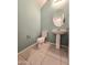 Powder room with tiled floor, neutral colored walls, pedestal sink, and toilet at 19954 W Moonlight Path, Buckeye, AZ 85326