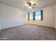 Spacious bedroom with plush carpeting and large windows for ample natural light at 19954 W Moonlight Path, Buckeye, AZ 85326