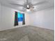 Spacious bedroom featuring a ceiling fan and a window providing ample natural light at 19954 W Moonlight Path, Buckeye, AZ 85326