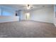 Expansive carpeted bonus room featuring neutral walls and ceiling fan at 19954 W Moonlight Path, Buckeye, AZ 85326