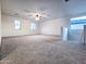 Spacious carpeted bonus room with ceiling fan and ample natural light from multiple windows at 19954 W Moonlight Path, Buckeye, AZ 85326