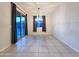 Dining area featuring tile floors, a sliding glass door, and an elegant chandelier at 19954 W Moonlight Path, Buckeye, AZ 85326