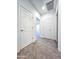Well-lit hallway with carpet and neutral walls, showcasing access to other rooms at 19954 W Moonlight Path, Buckeye, AZ 85326