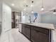 Kitchen island with granite countertops, stainless steel appliances, and wood cabinets at 19954 W Moonlight Path, Buckeye, AZ 85326
