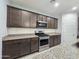 Kitchen featuring stainless steel appliances, granite countertops, and wooden cabinetry at 19954 W Moonlight Path, Buckeye, AZ 85326