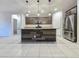 Kitchen island with granite countertops, wood paneling, pendant lights, and stainless steel appliances at 19954 W Moonlight Path, Buckeye, AZ 85326