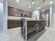 Kitchen featuring granite countertops, wood cabinets, a stainless steel refrigerator, and pendant lighting at 19954 W Moonlight Path, Buckeye, AZ 85326