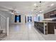 Open-concept living space with tile floors, a ceiling fan, and a kitchen island at 19954 W Moonlight Path, Buckeye, AZ 85326