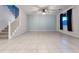 Living room with a ceiling fan, staircase, and tile flooring for easy maintenance at 19954 W Moonlight Path, Buckeye, AZ 85326
