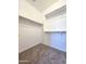 Well-organized walk-in closet featuring carpeted flooring and multiple shelving units at 19954 W Moonlight Path, Buckeye, AZ 85326