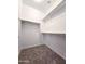 Carpeted walk-in closet with built-in shelving for storage at 19954 W Moonlight Path, Buckeye, AZ 85326