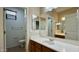 Bathroom features a large vanity, a framed mirror, and a view into the toilet and shower areas at 22507 N 31St Ave # 11, Phoenix, AZ 85027
