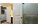 Bathroom showcases a shower with glass doors and a door leading to the vanity area at 22507 N 31St Ave # 11, Phoenix, AZ 85027