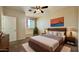 Comfortable bedroom featuring a ceiling fan, neutral walls, modern decor, and a window with natural light at 22507 N 31St Ave # 11, Phoenix, AZ 85027