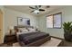 Comfortable bedroom with a ceiling fan, natural light, and tasteful decor at 22507 N 31St Ave # 11, Phoenix, AZ 85027