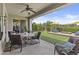 Covered patio featuring outdoor furniture and a well-manicured backyard with artificial turf and landscaping at 2466 E Aris Dr, Gilbert, AZ 85298