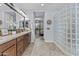 Bathroom with granite countertop, wood cabinets, dual mirrors, glass block wall and tile floor at 2466 E Aris Dr, Gilbert, AZ 85298