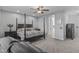Spacious primary bedroom featuring a four-poster bed, ceiling fan, and ensuite bath entrance at 2466 E Aris Dr, Gilbert, AZ 85298