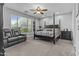 Large bedroom featuring a four-poster bed, ceiling fan and a large window with natural light at 2466 E Aris Dr, Gilbert, AZ 85298