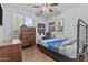 Well-lit bedroom featuring a single bed, ceramic wood-look flooring, and a view from the window at 2466 E Aris Dr, Gilbert, AZ 85298