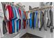 Organized walk-in closet with clothing rack and shelves, with shirts and other personal items hanging at 2466 E Aris Dr, Gilbert, AZ 85298