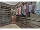 Custom walk-in closet with shelves, drawers, and hanging space, complete with display lighting and storage at 2466 E Aris Dr, Gilbert, AZ 85298
