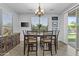 Bright dining room with a chandelier, large window, and sliding glass door to the outdoor space at 2466 E Aris Dr, Gilbert, AZ 85298