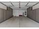 Spacious garage featuring ample storage cabinets, epoxy flooring, and organized layout at 2466 E Aris Dr, Gilbert, AZ 85298