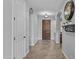 Welcoming hallway featuring tile flooring, arched doorways, and a wood front door at 2466 E Aris Dr, Gilbert, AZ 85298