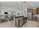 Spacious kitchen with a central island, stainless steel appliances, and open access to the living area at 2466 E Aris Dr, Gilbert, AZ 85298