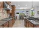 A view of the kitchen with stainless steel appliances and breakfast bar in an open-concept layout at 2466 E Aris Dr, Gilbert, AZ 85298