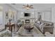 A stylish living room is featuring a fireplace, a cozy seating area, and a large TV for entertainment at 2466 E Aris Dr, Gilbert, AZ 85298