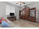 Entertainment room featuring a TV, shelving, and a comfortable couch at 2466 E Aris Dr, Gilbert, AZ 85298