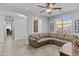 Inviting living room with tile flooring, a tan sectional sofa, and neutral wall color at 2466 E Aris Dr, Gilbert, AZ 85298