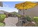 Cozy outdoor patio with brick pavers, metal seating, and lush greenery, perfect for relaxation and entertaining at 2466 E Aris Dr, Gilbert, AZ 85298