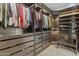 Custom walk-in closet with built-in shelving, drawers, and bench at 2466 E Aris Dr, Gilbert, AZ 85298