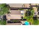 Overhead view showcasing a private backyard with a pool, patio, lawn and lush greenery, bordered by neighboring houses at 2551 W Sawtooth Way, San Tan Valley, AZ 85144