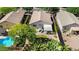 Aerial view of a private backyard featuring a swimming pool, a covered patio with lounge chairs, and verdant landscaping at 2551 W Sawtooth Way, San Tan Valley, AZ 85144