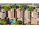 Aerial view of multiple backyards, showcasing a swimming pool, seating areas, and well-maintained landscaping within a residential area at 2551 W Sawtooth Way, San Tan Valley, AZ 85144