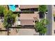 Aerial view featuring a backyard with a pool, small patio with seating, and a well-kept lawn area, bordered by lush greenery at 2551 W Sawtooth Way, San Tan Valley, AZ 85144