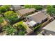 Aerial view of a well-maintained backyard, featuring a covered patio, green grass, and mature trees at 2551 W Sawtooth Way, San Tan Valley, AZ 85144