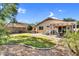 Manicured backyard with a lush lawn, paver patio, and mature landscaping, perfect for outdoor relaxation at 2551 W Sawtooth Way, San Tan Valley, AZ 85144