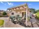 Backyard featuring covered patio with outdoor seating area, perfect for entertaining at 2551 W Sawtooth Way, San Tan Valley, AZ 85144