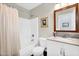 Bright bathroom featuring a shower-tub, vanity with granite countertop and framed mirror at 2551 W Sawtooth Way, San Tan Valley, AZ 85144