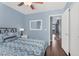 A inviting bedroom has wood floors and a view to an adjacent living area at 2551 W Sawtooth Way, San Tan Valley, AZ 85144