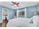 Bright bedroom with wood floors and a view to a bathroom at 2551 W Sawtooth Way, San Tan Valley, AZ 85144