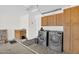 Spacious laundry room with updated washer and dryer and ample storage space at 2551 W Sawtooth Way, San Tan Valley, AZ 85144