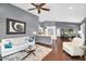 Comfortable open-concept living room features wood floors, bar seating, and ample natural light at 2551 W Sawtooth Way, San Tan Valley, AZ 85144