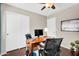 Cozy office with desk, wood laminate flooring and closet with sliding doors at 2551 W Sawtooth Way, San Tan Valley, AZ 85144