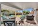Inviting covered patio featuring comfortable seating, a fire pit table, and a built-in grill for outdoor entertainment at 2551 W Sawtooth Way, San Tan Valley, AZ 85144